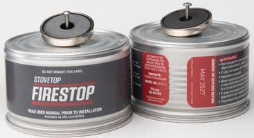 Two metal cans with sealed tops labeled for leak testing.