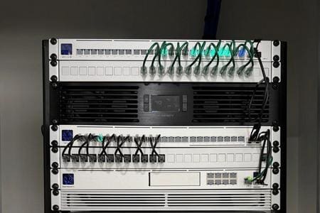 Two network patch panels with numerous connected Ethernet cables.