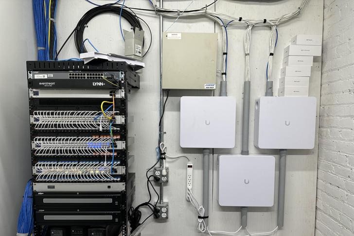 Network equipment and wireless access points installed on a wall.